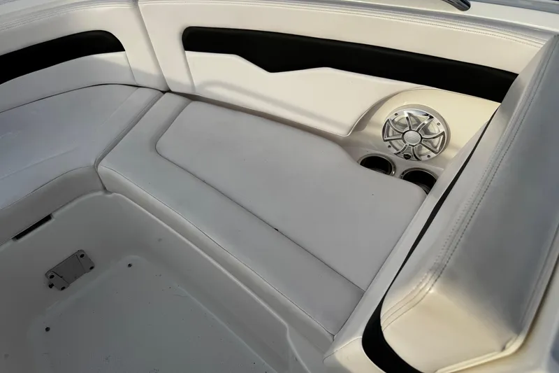Slide: The Image of 2019 Chaparral 246 SSi boat interior with white seating and speaker detail. - 8