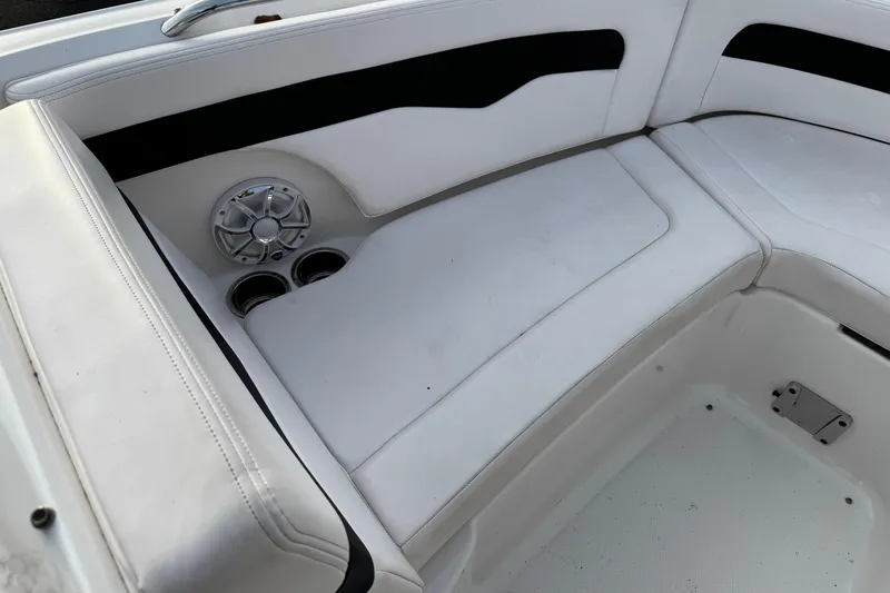 Slide: The Image of 2019 Chaparral 246 SSi boat interior with white seating and speaker system. - 9