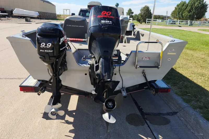 Slide: The Image of 2005 Tracker Targa 17 boat with dual Mercury outboard motors on a trailer. - 2