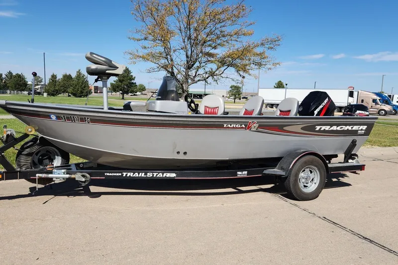 Slide: The Image of 2005 Tracker Targa 17 boat on trailer, parked outdoors on a sunny day. - 3