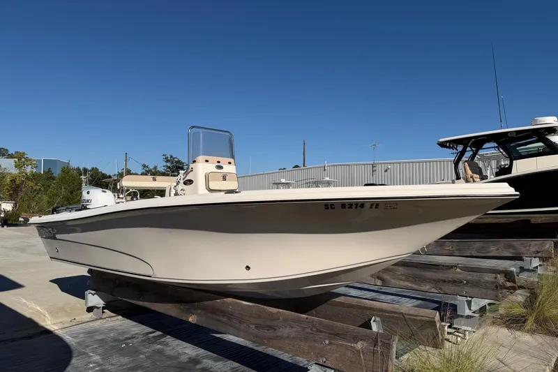 The Image of 2022 Sea Chaser 21 Sea Skiff boat on display outdoors, clear sky background. - 0