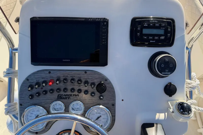 Slide: The Image of Control panel of 2022 Sea Chaser 21 Sea Skiff with Garmin display and Infinity audio system. - 10