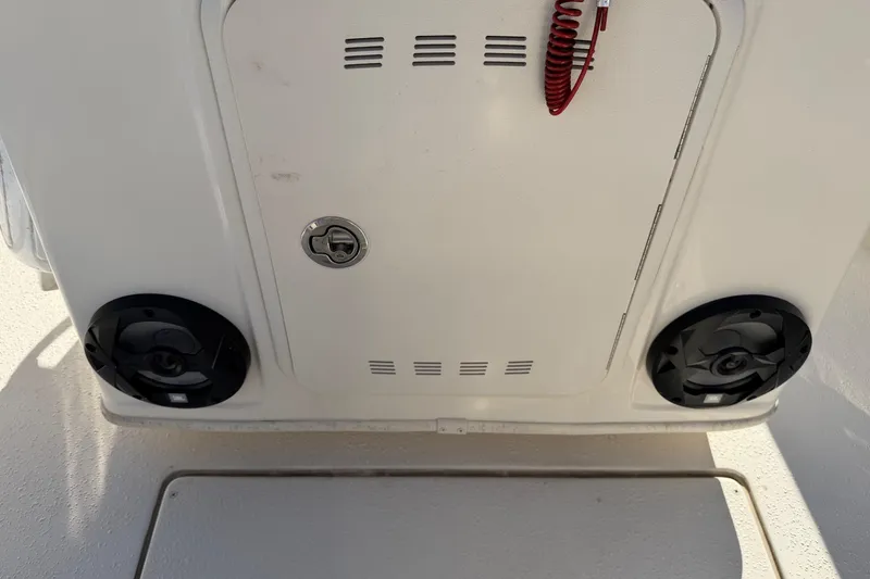 Slide: The Image of 2022 Sea Chaser 21 Sea Skiff boat console with speakers and storage compartment. - 12
