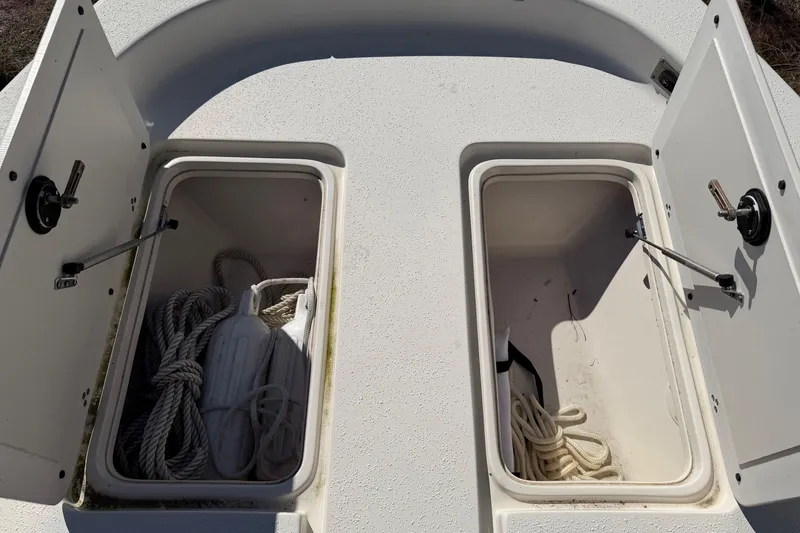 Slide: The Image of Open storage compartments on 2022 Sea Chaser 21 Sea Skiff boat deck. - 16