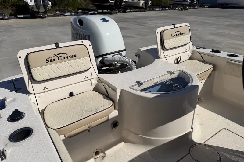 Slide: The Image of 2022 Sea Chaser 21 Sea Skiff boat interior with Suzuki engine and seating. - 18