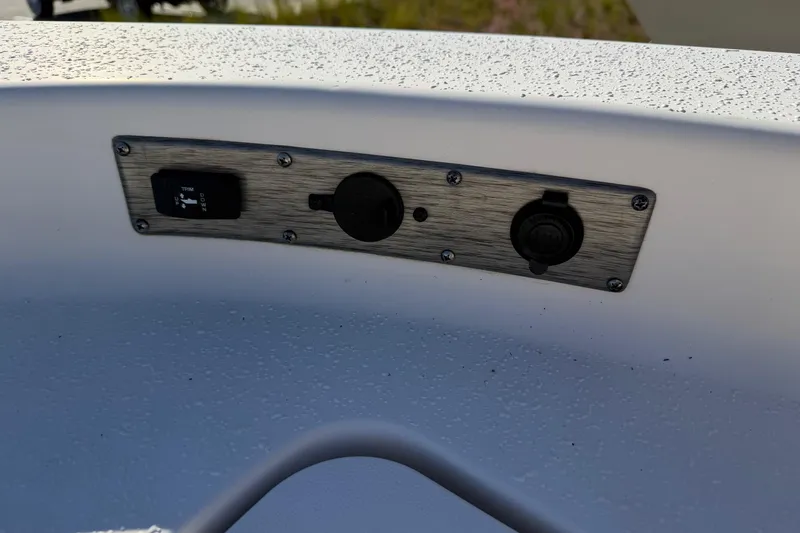 Slide: The Image of Control panel on 2022 Sea Chaser 21 Sea Skiff boat, featuring trim switch and outlets. - 27