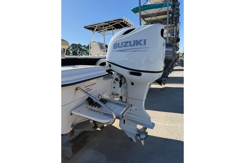 Slide: The Image of 2022 Sea Chaser 21 Sea Skiff with Suzuki outboard motor in a marina. - 33