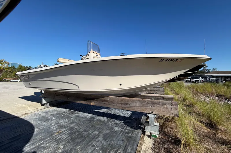 Slide: The Image of 2022 Sea Chaser 21 Sea Skiff boat on dry dock under clear blue sky. - 4