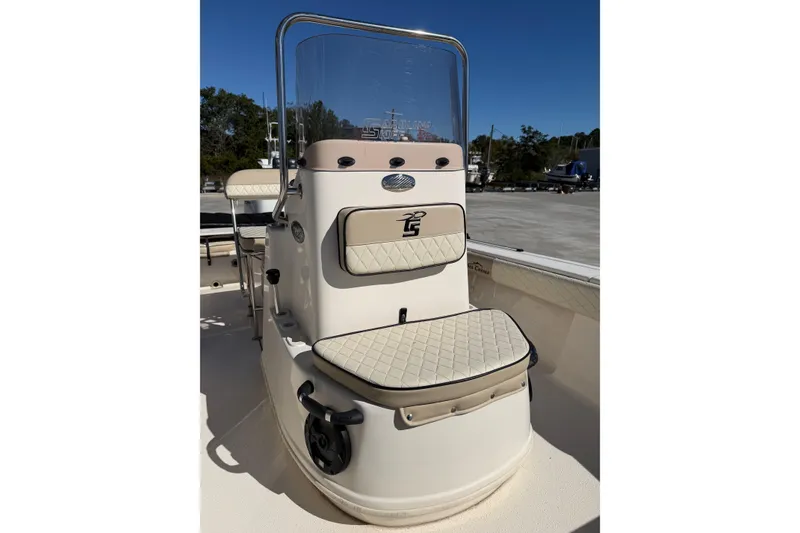Slide: The Image of 2022 Sea Chaser 21 Sea Skiff boat console with cushioned seating and clear windshield. - 7