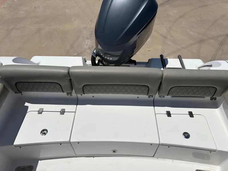 Slide: The Image of 2021 Sportsman Heritage 241 Center Console boat with cushioned seating and storage compartments. - 12