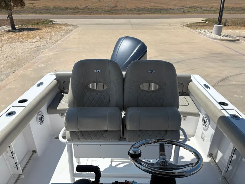 Slide: The Image of 2021 Sportsman Heritage 241 Center Console boat interior with dual seats and steering wheel. - 20