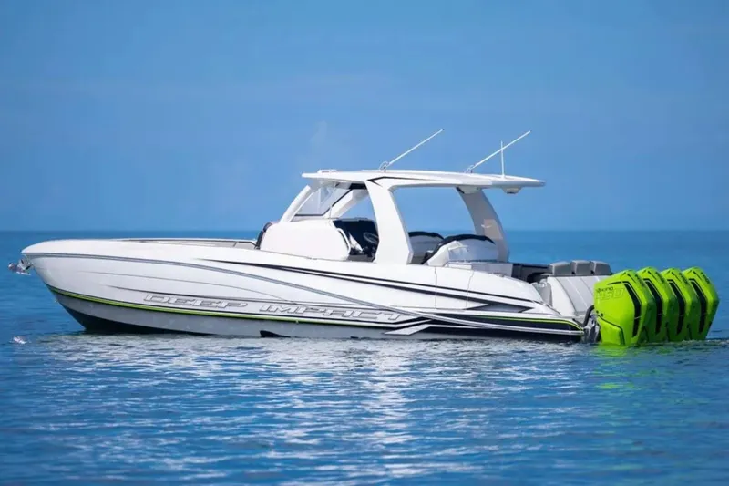 Slide: The Image of 2026 Deep Impact 399 Sport boat with vibrant green engines on calm blue water. - 11
