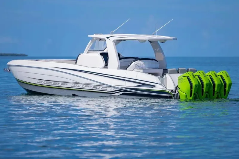 Slide: The Image of 2026 Deep Impact 399 Sport boat with vibrant green engines on calm blue water. - 12