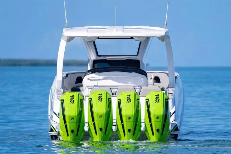 Slide: The Image of 2026 Deep Impact 399 Sport boat with four vibrant green outboard motors on water. - 13