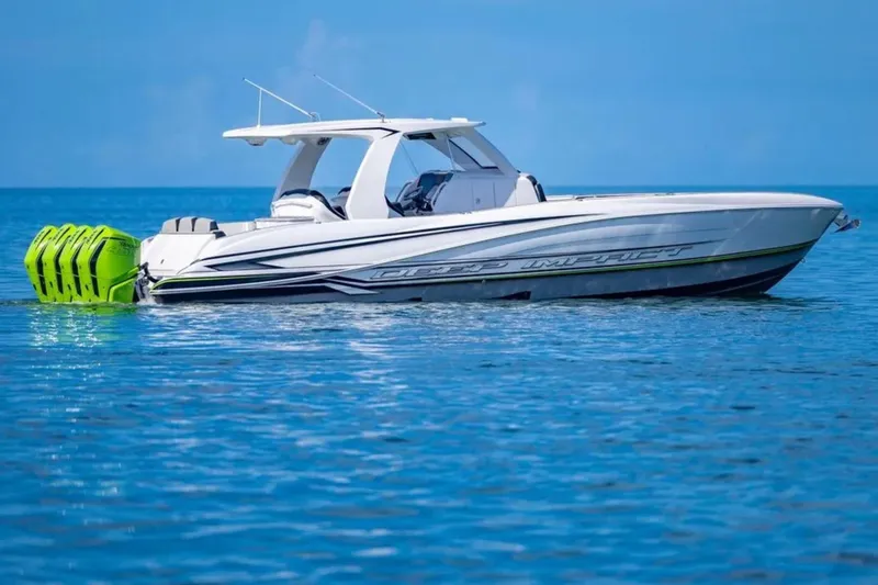 Slide: The Image of 2026 Deep Impact 399 Sport boat with vibrant engines on calm blue water. - 15