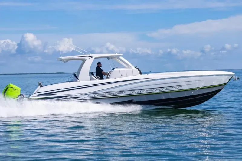 Slide: The Image of 2026 Deep Impact 399 Sport boat cruising on open water under a clear sky. - 18