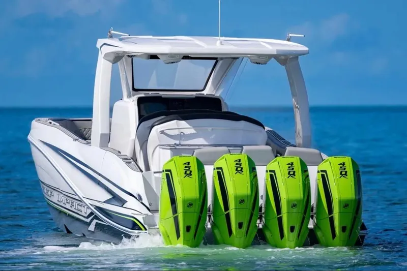 Slide: The Image of 2026 Deep Impact 399 Sport boat with four green 450R outboard engines on blue water. - 2