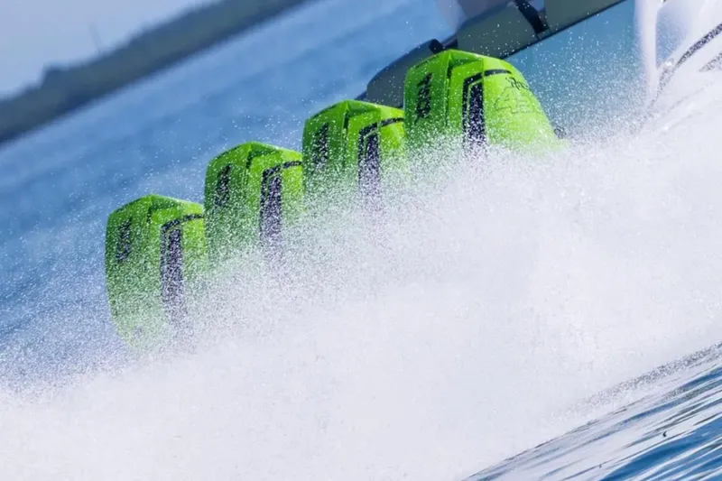 Slide: The Image of Five green outboard motors on a 2026 Deep Impact 399 Sport boat, creating a splash. - 20
