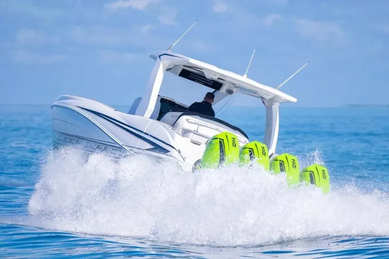 Slide: The Image of Four green Racing 450 outboard motors on a Deep Impact 399 Sport boat, 2026 model. - 27