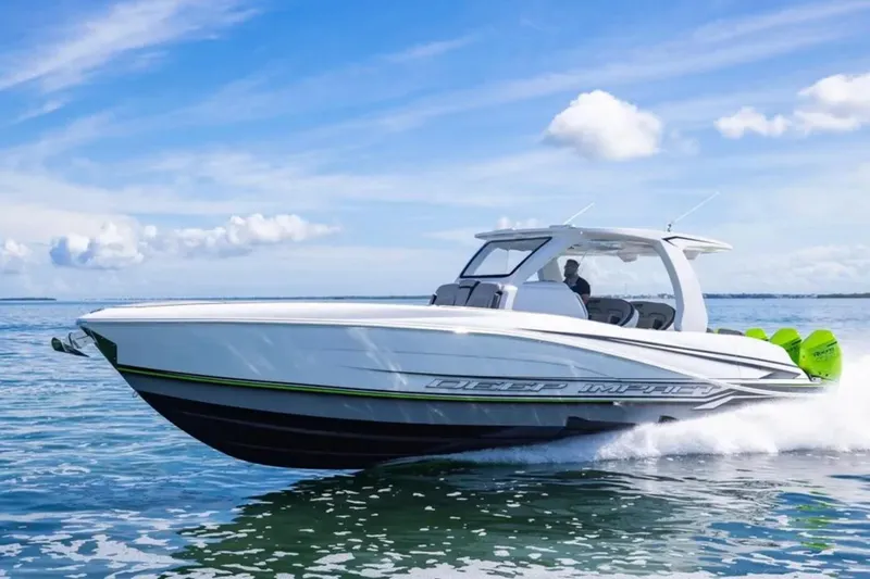 Slide: The Image of 2026 Deep Impact 399 Sport boat cruising on open water under a clear blue sky. - 30