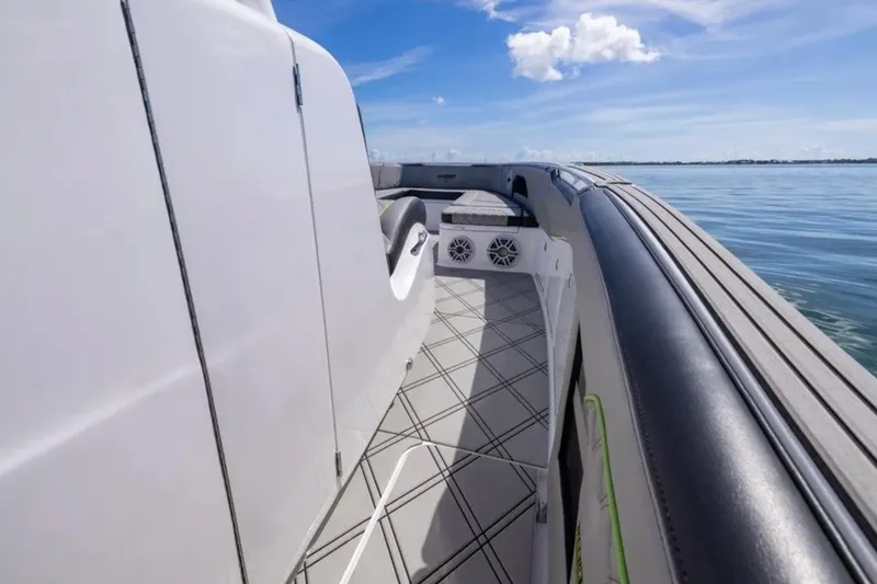 Slide: The Image of 2026 Deep Impact 399 Sport boat deck with sleek design and ocean view. - 41