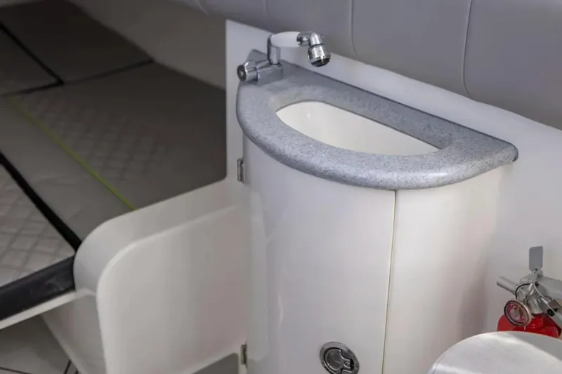 Slide: The Image of Interior of 2026 Deep Impact 399 Sport boat featuring a compact sink and faucet. - 43