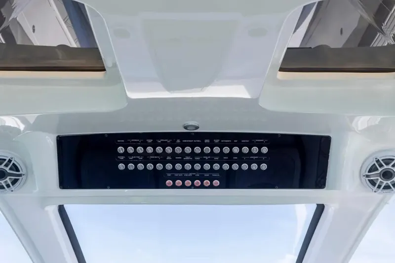Slide: The Image of Control panel of 2026 Deep Impact 399 Sport boat, featuring multiple buttons and speakers. - 46
