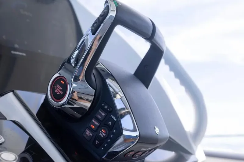 Slide: The Image of Close-up of 2026 Deep Impact 399 Sport boat throttle control. - 47