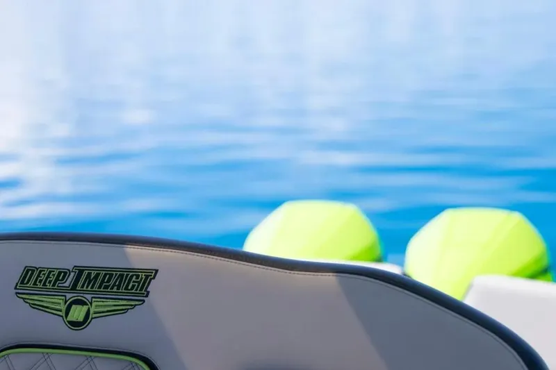 Slide: The Image of 2026 Deep Impact 399 Sport boat on calm blue water, featuring logo detail. - 51