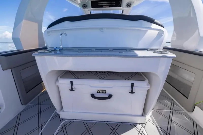 Slide: The Image of 2026 Deep Impact 399 Sport boat interior with Yeti cooler and sink. - 55