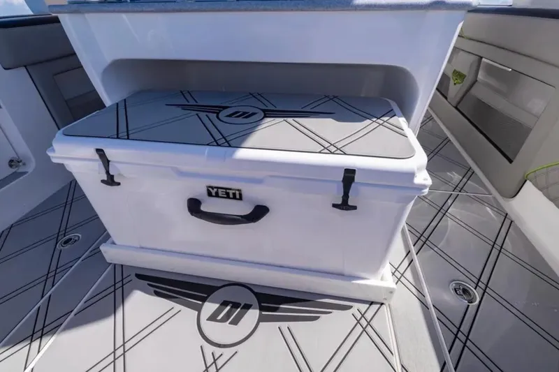 Slide: The Image of YETI cooler on 2026 Deep Impact 399 Sport boat with custom flooring design. - 56