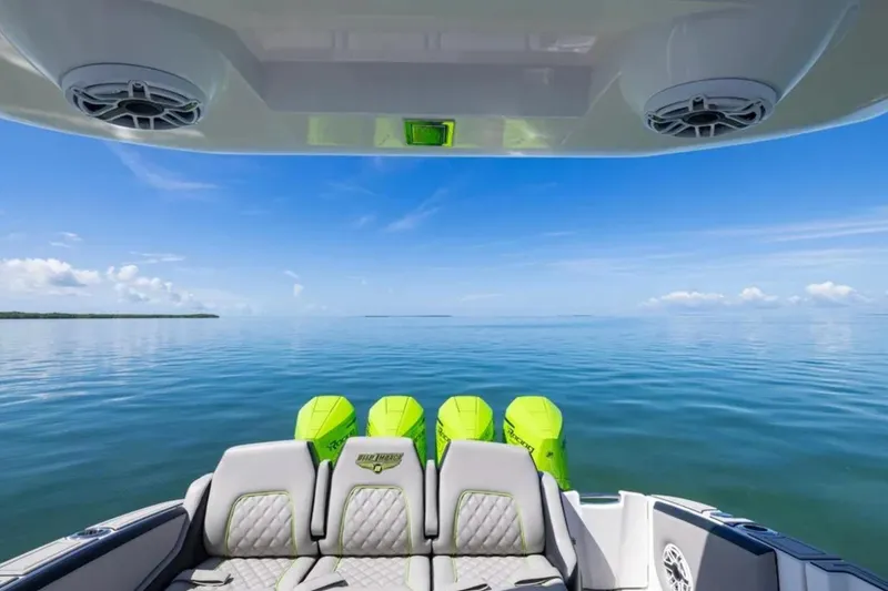 Slide: The Image of 2026 Deep Impact 399 Sport boat on calm ocean with clear blue sky. - 59