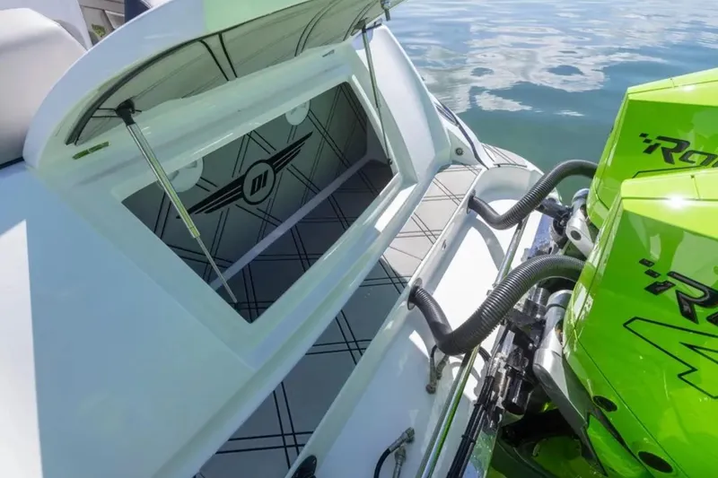 Slide: The Image of 2026 Deep Impact 399 Sport boat with open storage and vibrant green engines. - 65