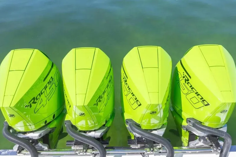 Slide: The Image of Four neon green Racing 450 outboard motors on a Deep Impact 399 Sport boat, 2026 model. - 66
