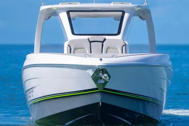 Slide: The Image of 2026 Deep Impact 399 Sport boat on clear blue water, front view. - 8