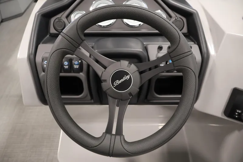 Slide: The Image of Steering wheel of 2026 Bentley Pontoons 220 Navigator boat, featuring modern dashboard controls. - 16