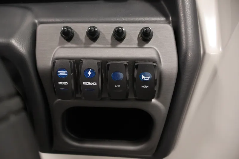 Slide: The Image of Control panel of 2026 Bentley Pontoons 220 Navigator with labeled switches for stereo, electronics, and horn. - 19