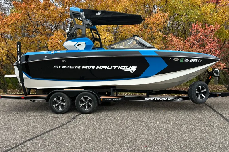 Slide: The Image of 2019 Nautique Super Air Nautique G21 boat on trailer, autumn foliage background. - 1