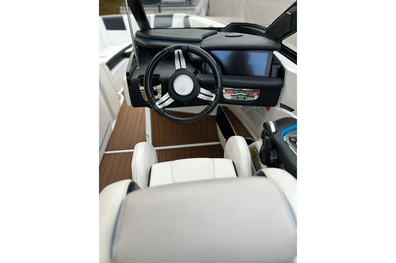 Slide: The Image of Interior of 2019 Nautique Super Air Nautique G21 boat with steering wheel and dashboard. - 10