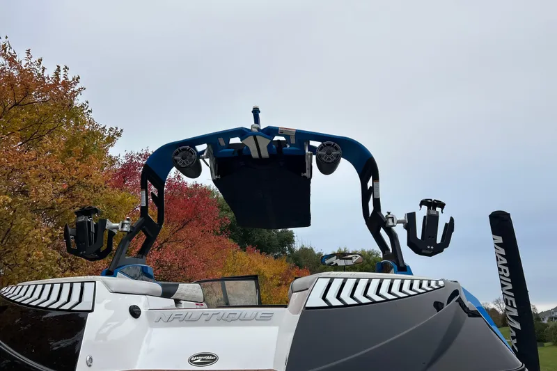 Slide: The Image of 2019 Nautique Super Air Nautique G21 boat with autumn foliage background. - 12