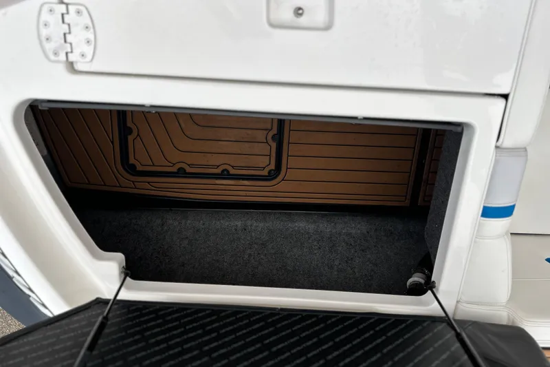 Slide: The Image of Open storage compartment in a 2019 Nautique Super Air Nautique G21 boat. - 14