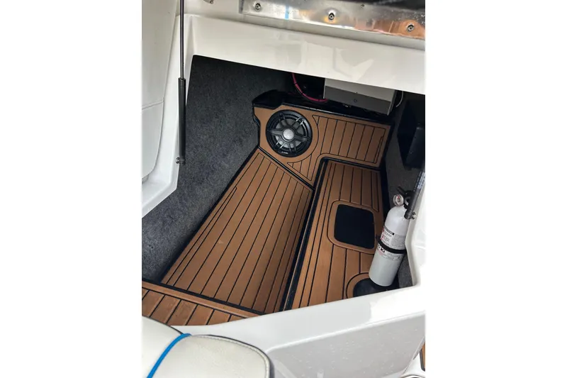 Slide: The Image of 2019 Nautique Super Air Nautique G21 interior with wood flooring and speaker system. - 16