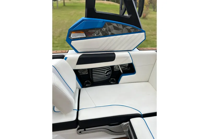 Slide: The Image of 2019 Nautique Super Air Nautique G21 interior with white and blue seating, modern design. - 19