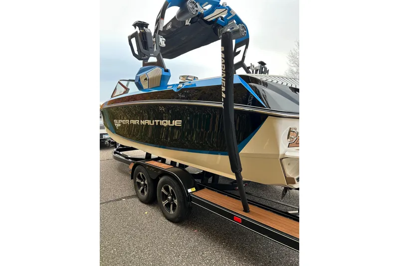 Slide: The Image of 2019 Nautique Super Air Nautique G21 boat on trailer, featuring sleek design and vibrant colors. - 4