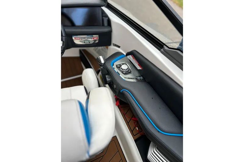 Slide: The Image of Interior of 2019 Nautique Super Air Nautique G21 boat, featuring sleek dashboard controls. - 8