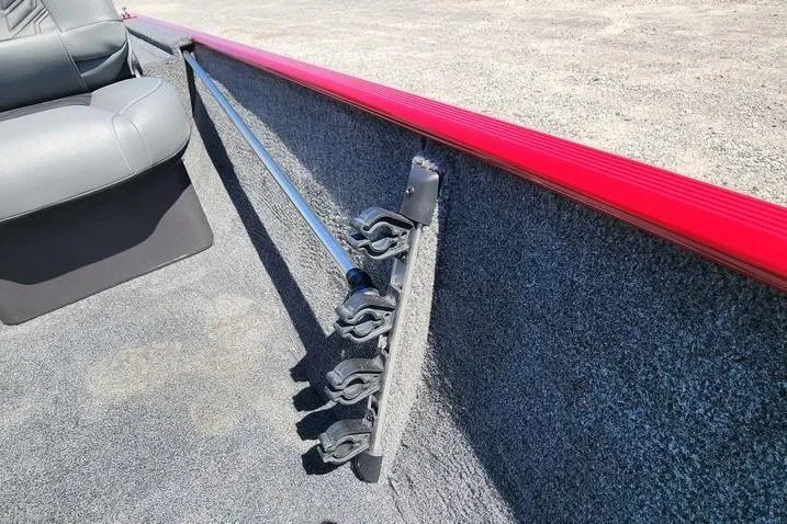 Slide: The Image of 2026 Tracker Bass Tracker Classic XL interior with rod holders and red trim. - 17