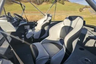 Slide: The Image of 2019 Tracker Pro Guide V-175 WT boat interior with two seats, steering wheel, and dashboard. - 2