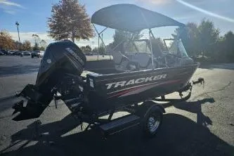 Slide: The Image of 2019 Tracker Pro Guide V-175 WT boat with canopy in parking lot. - 9