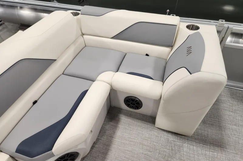 Slide: The Image of 2026 Avalon Venture Cruise Rear Bench with gray and white upholstery, featuring cup holders and speakers. - 11