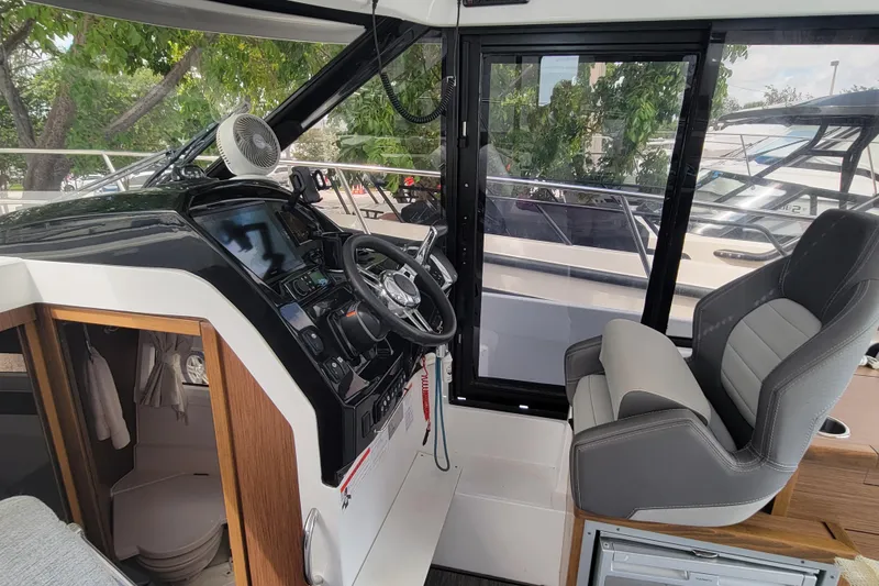 Slide: The Image of 2023 Jeanneau NC 895 boat interior with modern helm and seating. - 12
